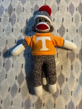 Sock Monkey Plush with Orange Tee Shirt with T on it.